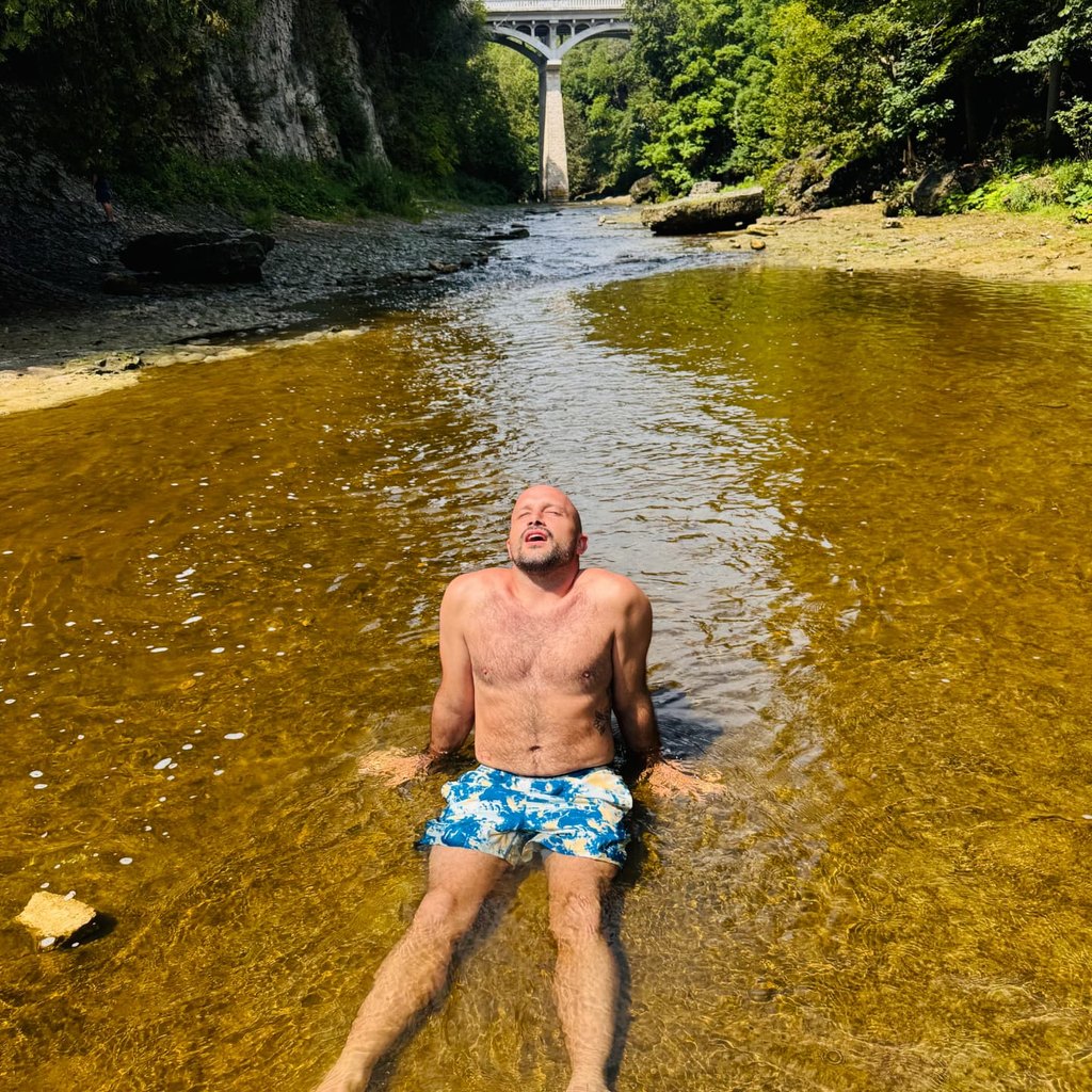 Man relaxing in a cool river on a summer afternoon