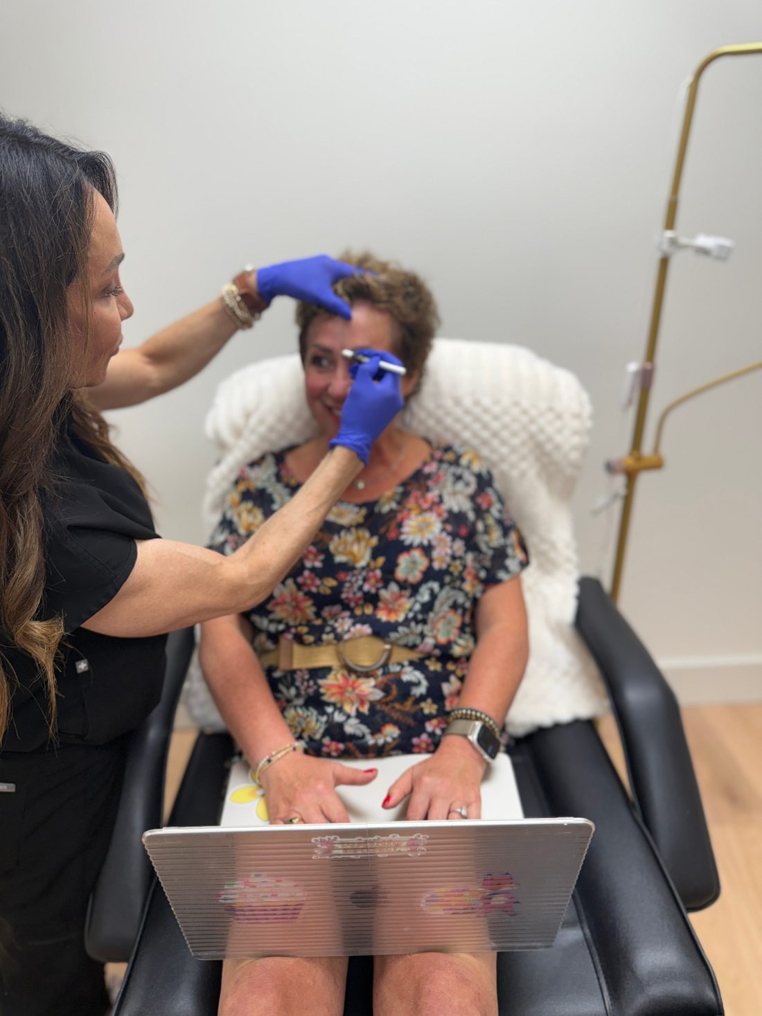 Kelli Kleckner, RN BSN, mapping brow injection points on a patient at TRU Integrative Wellness in Downers Grove